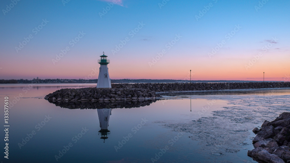 The Lighthouse Reflected in the River After Sunset