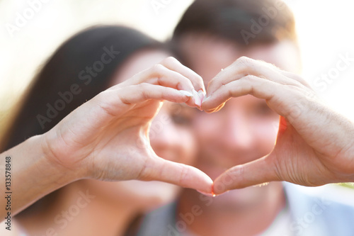 Young couple holding hands ...