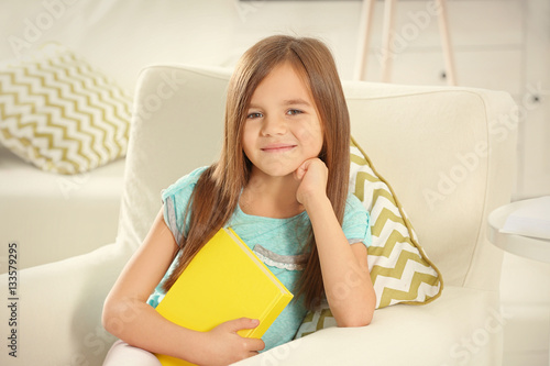 Cute little girl with book ...