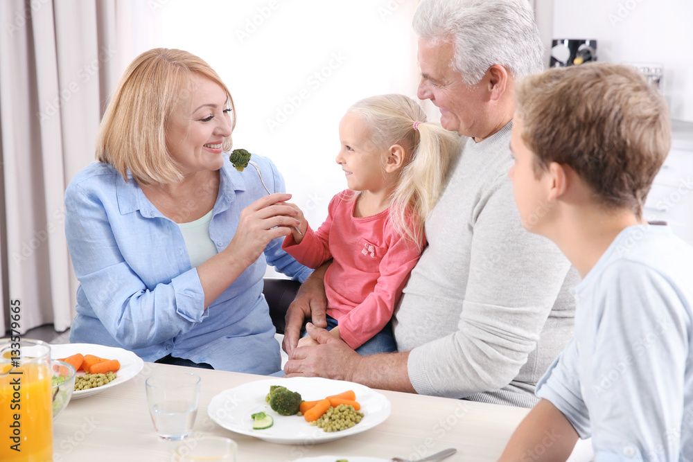 Happy family having lunch in kitchen Happy family having lunch in kitchen