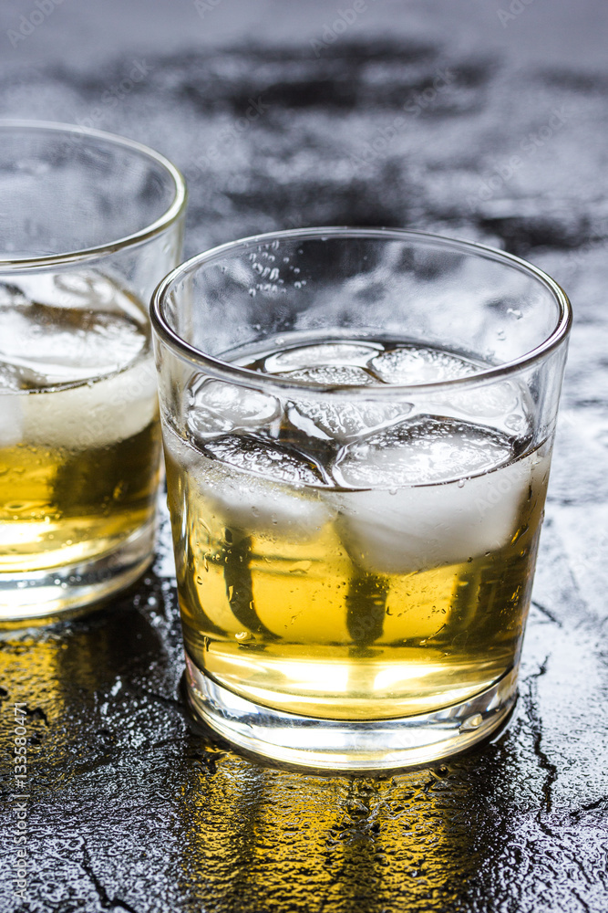 glass of whiskey on dark background glass of whiskey on dark background