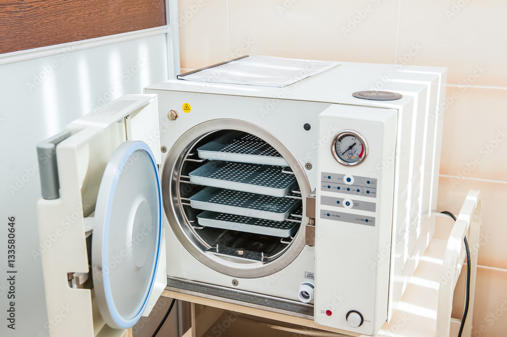 Modern laboratory autoclave sterilizer on the table Modern laboratory autoclave sterilizer on the table