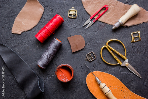 leather craft instruments on dark background top view mock up