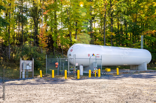 White Propane Tank on a Sunny Autumn Day. Lens Flare.