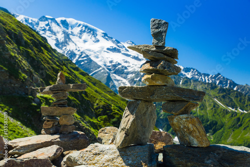 Two stacked stone figures sit along the Tour du Mont Blanc in the French Alps