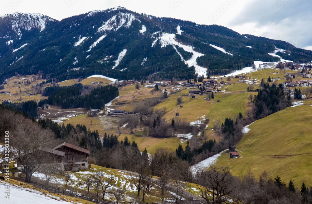 Beautiful view of the mountain and green village in winter without snow
