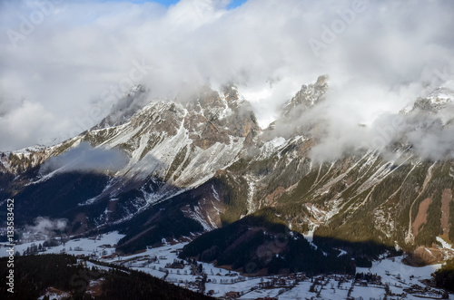 Beautiful view of the snow-covered mountains and low clouds in Austria