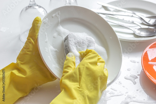 concept of woman washing dishes on white background photo