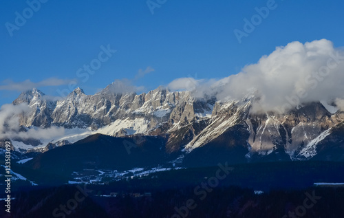 Beautiful view of the snow-covered mountains and low clouds in Austria
