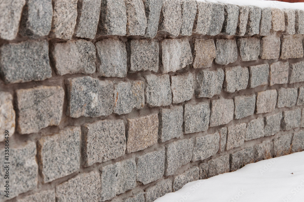 Wall of granite stones. Wall of granite stones.