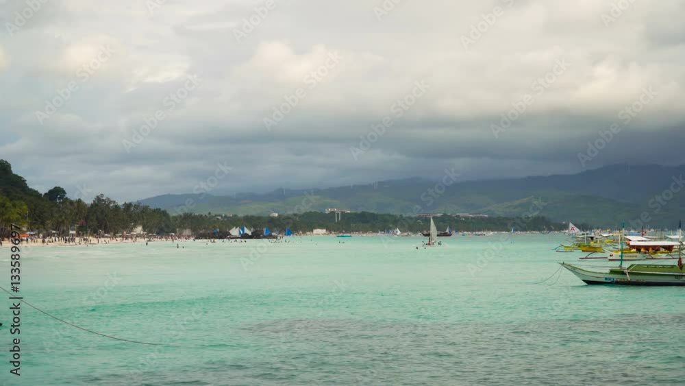 Beach with tourists, sea, sand,wave. Tropical beach, blue sky, clouds. Seascape ocean and beautiful beach paradise. Philippines Boracay. 4K video Travel concept Beach with tourists, sea, sand,wave. Tropical beach, blue sky, clouds. Seascape ocean and beautiful beach paradise. Philippines Boracay. 4K video Travel concept