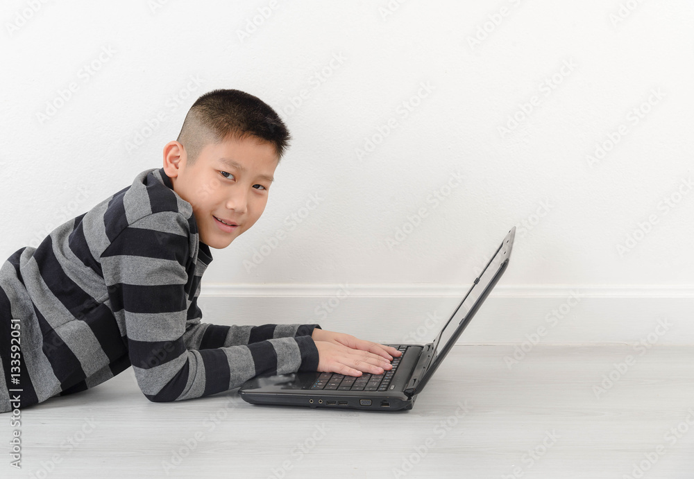 Asian boy using laptop at home Asian boy using laptop at home