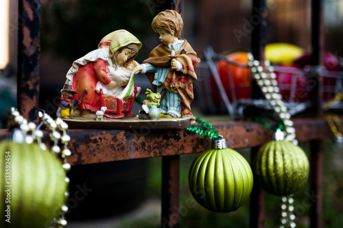 Fotografija Christmas decorations brighten a rusted iron fence