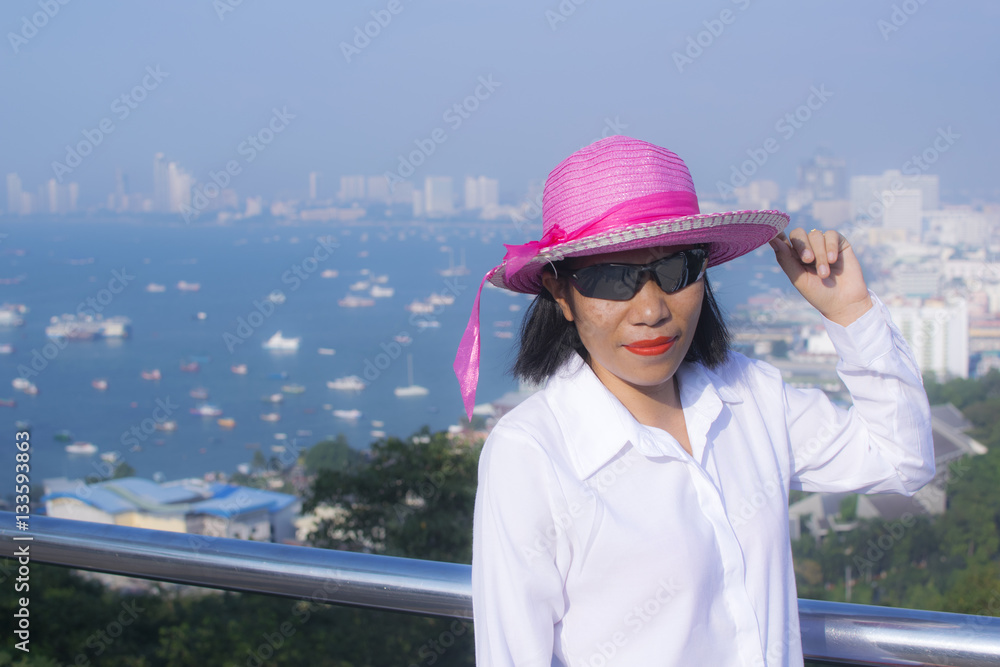 Pretty model woman posing on the top view of Pattaya, Thailand