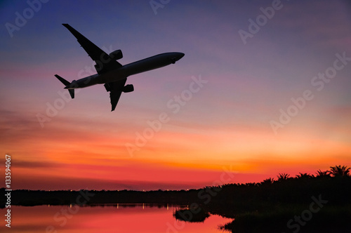Air plane silhouette over the sunset cloud