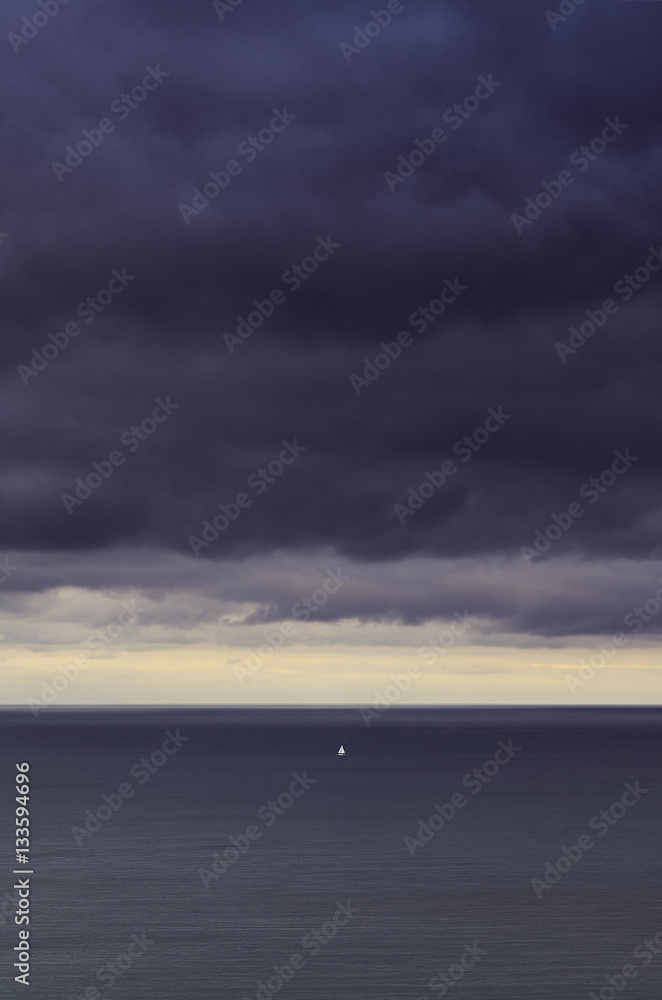 A lone boat in a storm at sea