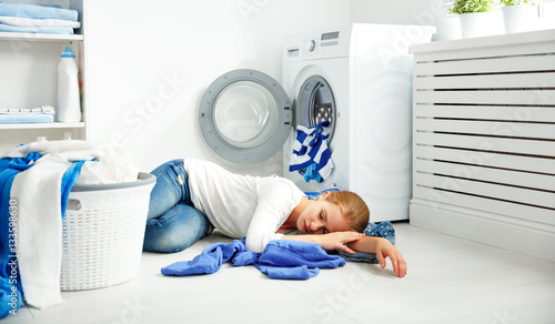 tired unhappy woman housewife is engaged in the laundry 