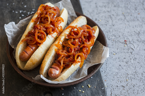 Hot dog with New York street style tomato onion sauce on a wooden background