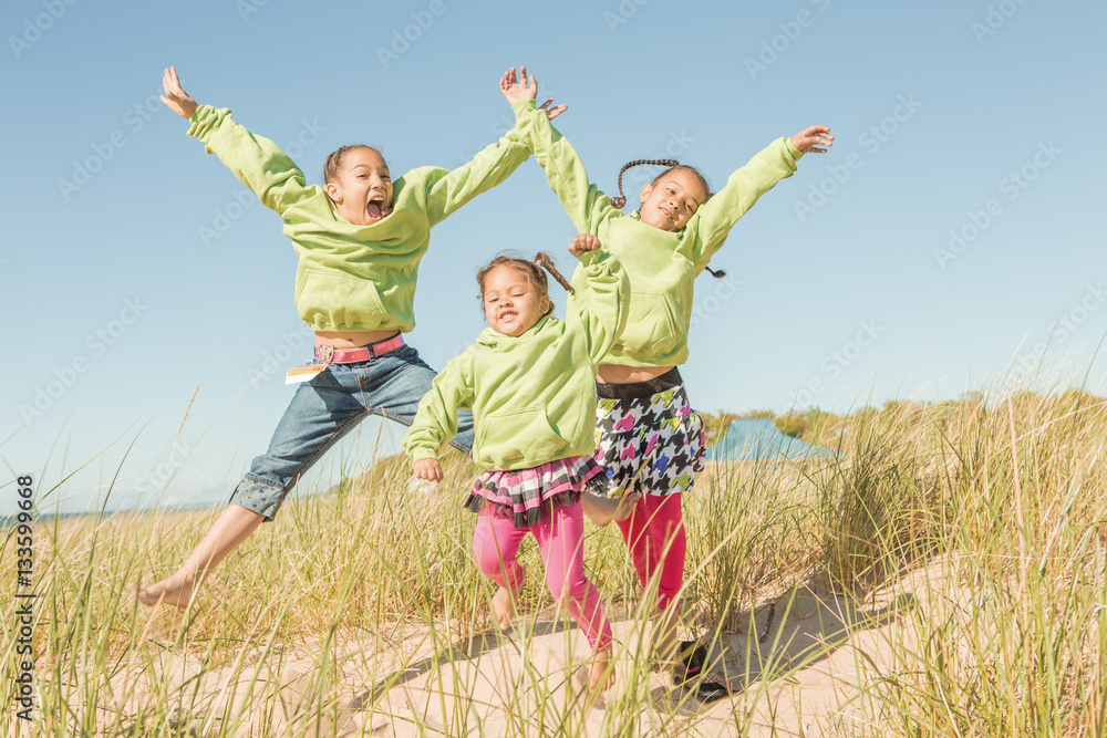 Children jumping at the beach Children jumping at the beach