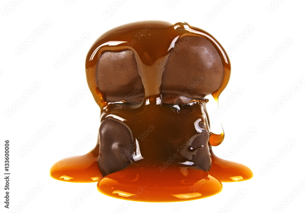 Two chocolate candies in caramel sauce on a white background Two chocolate candies in caramel sauce on a white background
