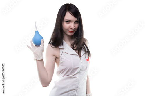 Brunette nurse with medical enema photo