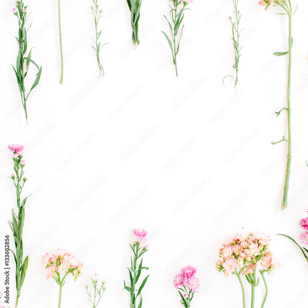 Frame with colorful wildflowers, green leaves, branches on white background. Flat lay, top view. Valentine's background Frame with colorful wildflowers, green leaves, branches on white background. Flat lay, top view. Valentine's background