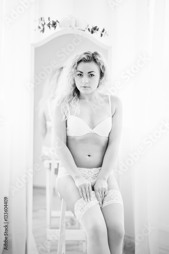 Curly blonde girl in underwear background mirror indoor white ro