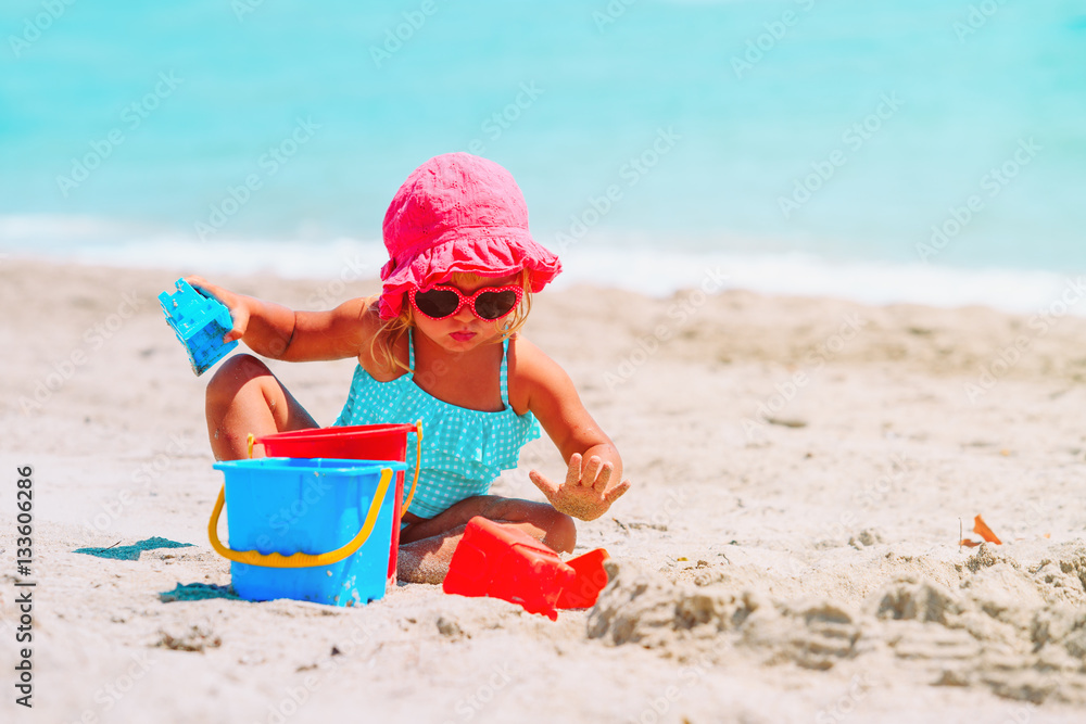 cute little girl play with sand on beach cute little girl play with sand on beach