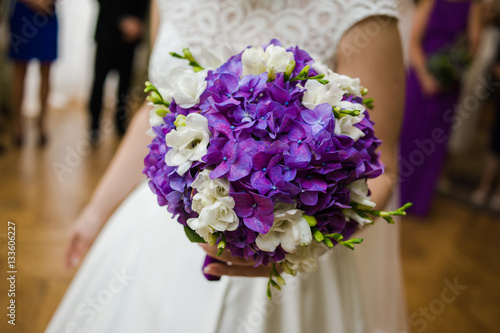 Beautiful bride and groom with bouquet before wedding ceremony