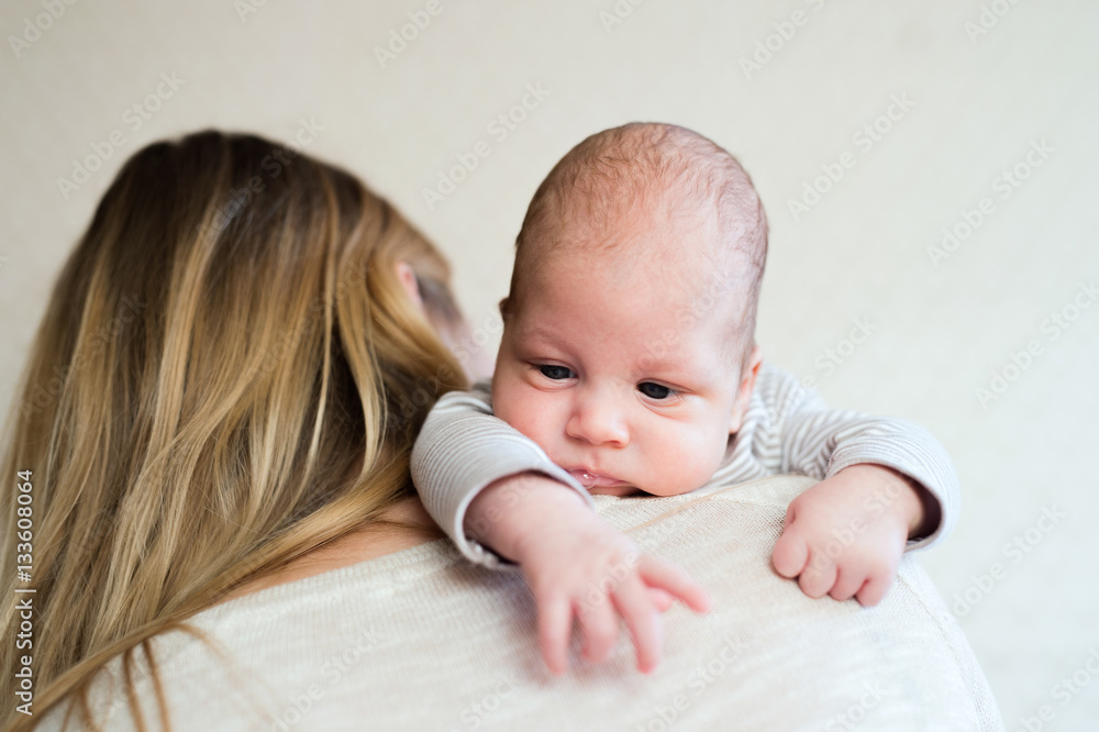 Unrecognizable young mother holding baby son in her arms Unrecognizable young mother holding baby son in her arms