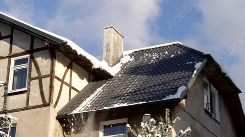 snow falling from the roof