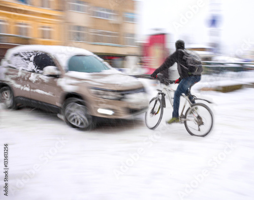 Dangerous city traffic situation with cyclist and car
