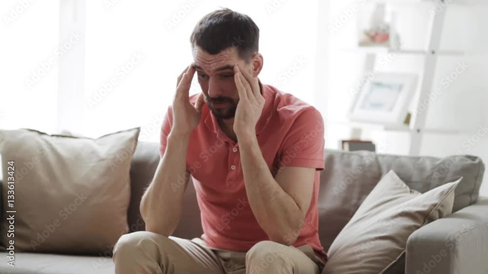 man suffering from headache at home man suffering from headache at home