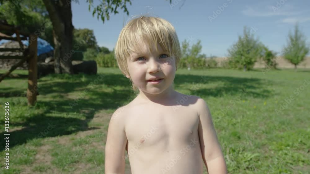 custom made wallpaper toronto digitalA young boy repeatedly gives thumbs up from alternating hands in a summer garden. He dives below camera at the end. 4k.