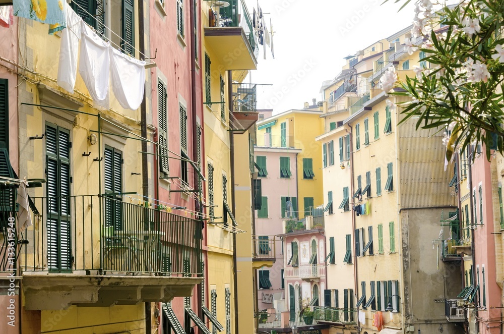 Riomaggiore village, La Spezia, Liguria, northern Italy. View of the colourful houses on steep hills and laundry on balconies. Part of the Cinque Terre National Park and a UNESCO World Heritage Site.