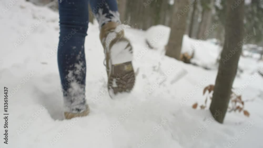 Female legs with winter shoes walking through fluffy friable snow in cold beautiful sunny day. Female legs with winter shoes walking through fluffy friable snow in cold beautiful sunny day.