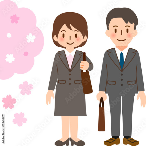 スーツを着た若い男女と桜　新入社員