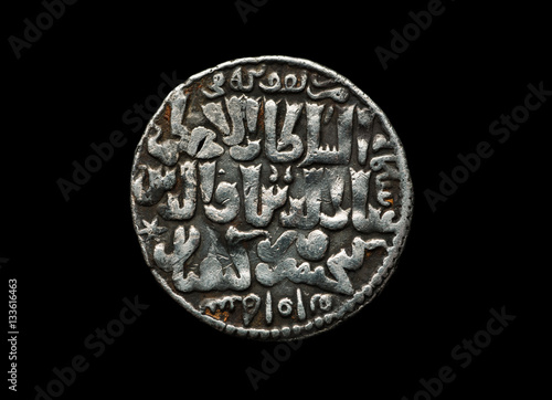 Obraz na płótnie Ancient Seljuk silver coin with text on it isolated on black w salonie