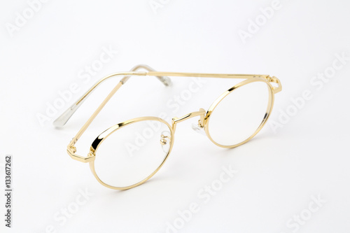 Classic gold round glasses on white background