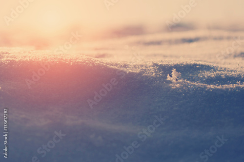 beautiful  snow natural background. Winter field in warm sunset. natural snow texture. instagram filter, retro style photo