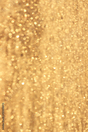 Abstract gold glitter background. Twinkled texture. Bokeh ligh