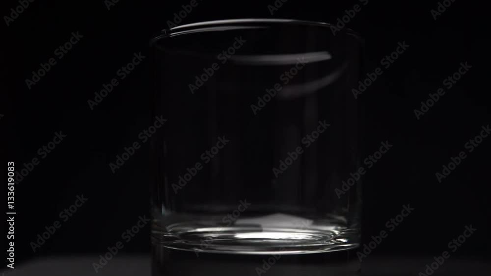 Pouring water in glass on black background slowmotion 120 FPS Pouring water in glass on black background slowmotion 120 FPS