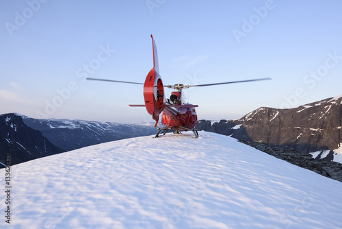 Helicopter on snowy peak photo