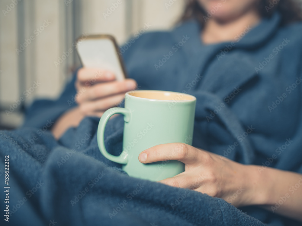 Young woman drinking tea in bed Young woman drinking tea in bed