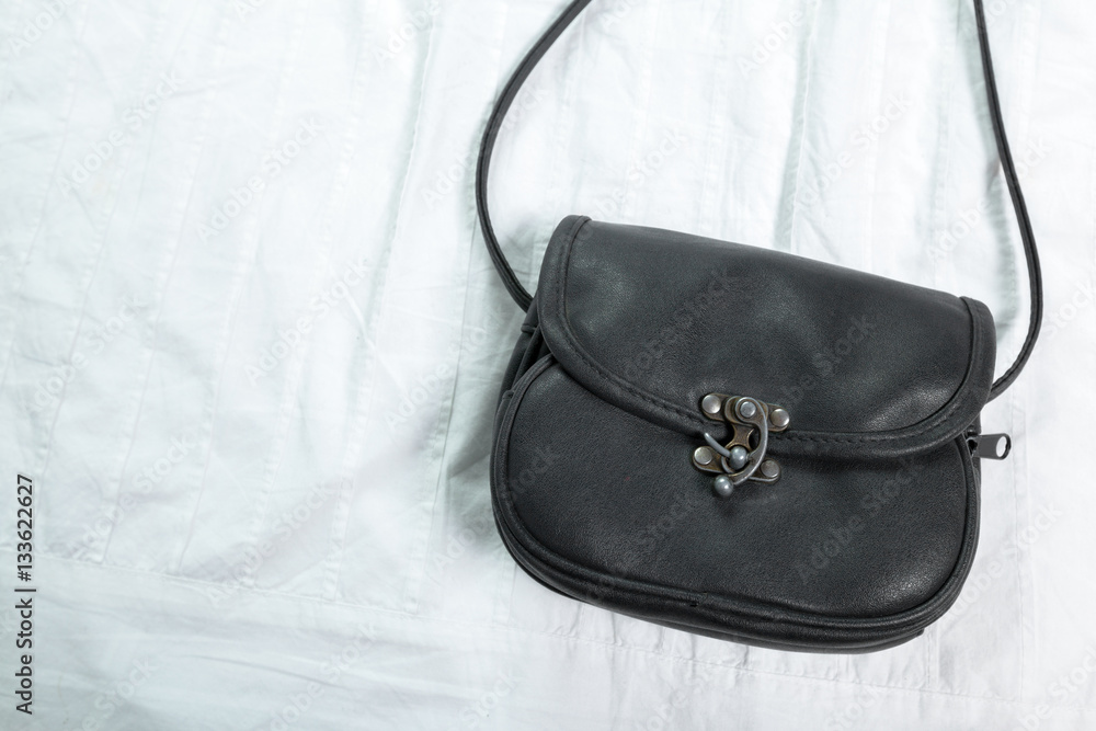 Female bag on white textile Female bag on white textile