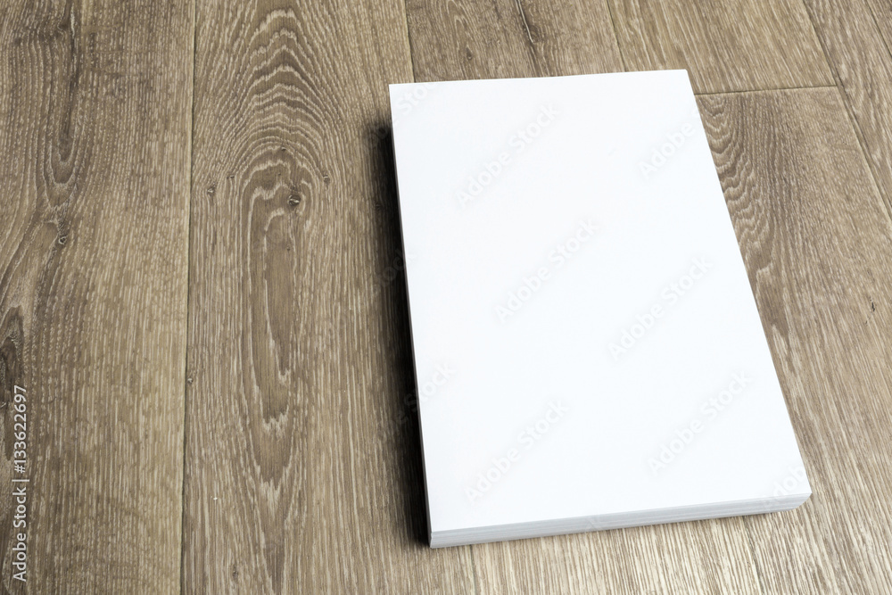 Blank paper on wood table Blank paper on wood table