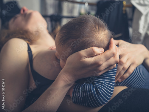 Little baby breastfeeding in bed