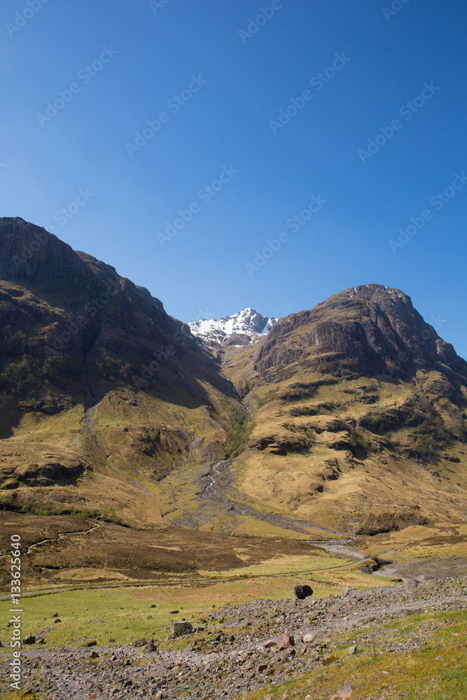 Glencoe Scotland UK famous Scottish glen with view of mountains in Lochaber Scottish Highlands sunny with blue sky Glencoe Scotland UK famous Scottish glen with view of mountains in Lochaber Scottish Highlands sunny with blue sky