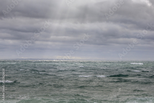 Sunrays on a stormy ocean © Rob
