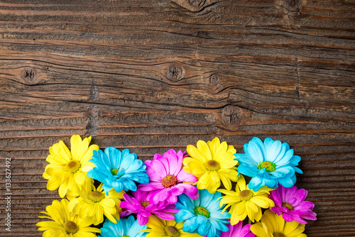 Colorful flowers on an old wooden background